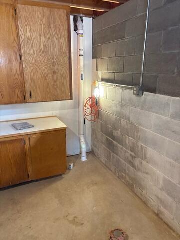 Before: Our Service Technician, Canon, suggested securing a new sump pump in the corner of the basement.