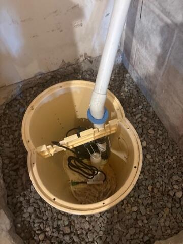 During: Our Foreman, Jeus, and his crew worked hard to secure the TripleSafe sump pump.