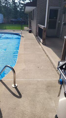 Sinking concrete slabs around the pool create jagged edges and dangerous trip hazards for anyone walking barefoot.