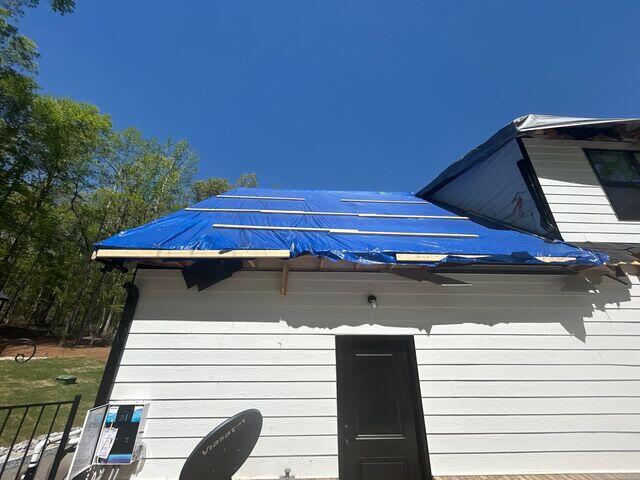 Emergency roof tarping protects the interior from further damage and water intrusion.