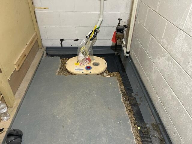 During: Our Foreman, Kiko, and his crew secured the WaterGuard and TripleSafe sump pump.