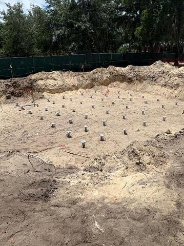 Helical piers installed and new construction brackets in place