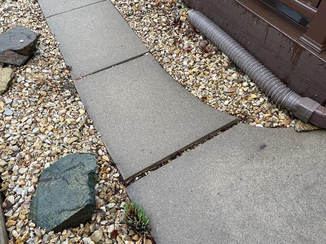 Before: Our Design Specialist, Romeo, suggested lifting and leveling the walkway back to its original height.