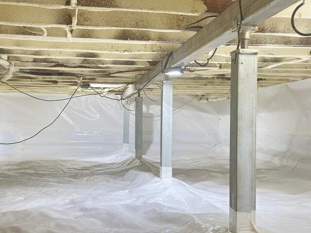 Crawl space in Feasterville Trevose, PA fully protected with CleanSpace vapor barrier and stabilized using SmartJack supports, creating a dry environment while restoring structural support to the home's floor system.
