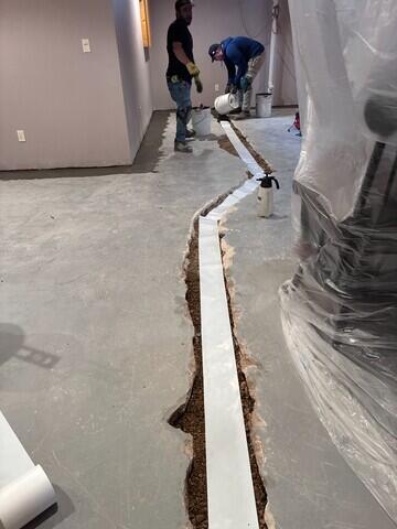 During: Our Foreman, Raul, and his crew started by securing WaterGuard around the basement perimeter.