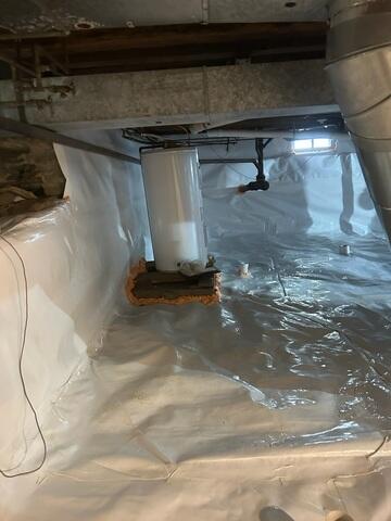 To address the moisture problem, we installed a full CleanSpace encapsulation system. This included a durable vapor barrier applied across the ground and along the crawl space walls, effectively sealing the area from moisture in the soil. A drainage solution was also implemented to manage any water entering the space and direct it away from the home.

To restore proper support, we installed a SmartJack system beneath the affected areas of the home.