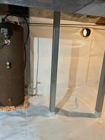 To address the moisture problem, we installed a full CleanSpace encapsulation system. This included a durable vapor barrier applied across the ground and along the crawl space walls, effectively sealing the area from moisture in the soil. A drainage solution was also implemented to manage any water entering the space and direct it away from the home.

To restore proper support, we installed a SmartJack system beneath the affected areas of the home.