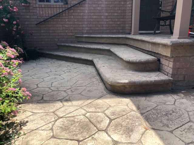 The initial assessment of the front entrance revealed a significant drop in the stamped concrete steps. The settlement created a jagged gap where the stairs met the porch pillar, making the first step uneven and unsafe for anyone entering the home.