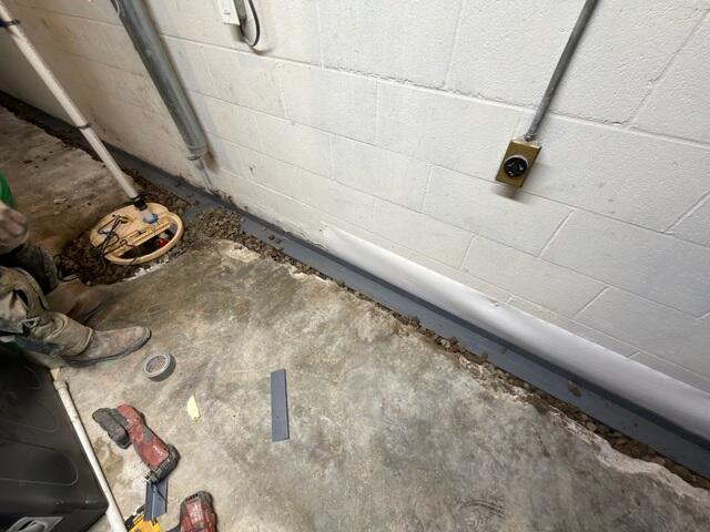 In this area, the crew dug a new sump pit and installed the TripleSafe sump liner & sump pump. They also installed WaterGuard along the perimeter.
