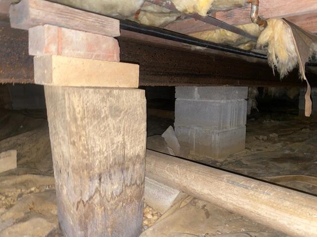 Bricks added onto a support to try to fix the bouncy floors,which didn't repair it.