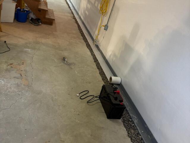 We made sure to properly pitch and grade our WaterGuard drains so all the water flows down into the sump pump. The tape you see rolled across the top of the gutter drains makes concealing the drains with concrete easier and better.