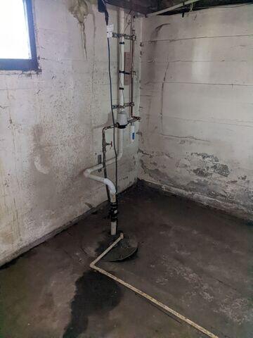 Before: Our Design Specialist, Jesse, suggested waterproofing the entire basement.