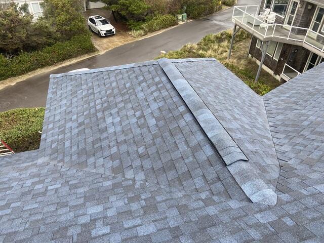 The roof is complete with bold, timeless Atlantic Blue shingles, crisp white gutters, and flashing. Every detail was built to last, with reinforced decking, sealed joints, and ice & water protection throughout.