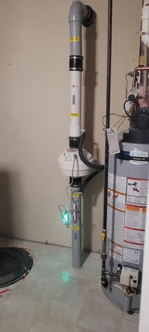 Radon mitigation system with muffler