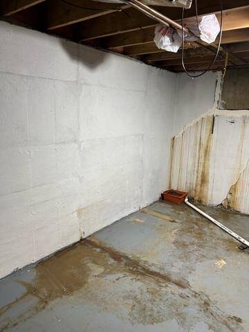 Before: Our Service Technician, Bradey, suggested waterproofing the entire water-damaged basement.
