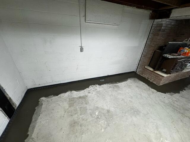 The crew re-concretes the floors after installing WaterGuard for a seamless finish.