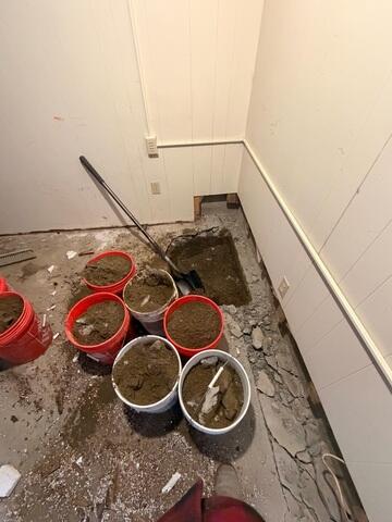 The pit is being dug out for the future home of the sump pump.