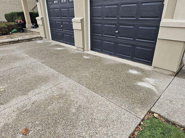 Precision at work! You can see our injection points strategically placed along the garage lip. Our polyurethane injection process allows us to lift these heavy slabs back to their original height with minimal disruption.