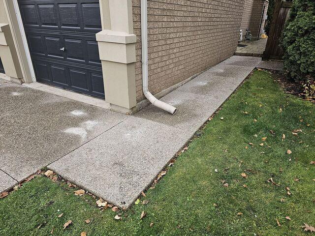 We didn't stop at the driveway. The side walkway was also sinking and sloping toward the home. By injecting our stabilizing material, we're able to level the path and ensure water runs away from the house, not toward it.