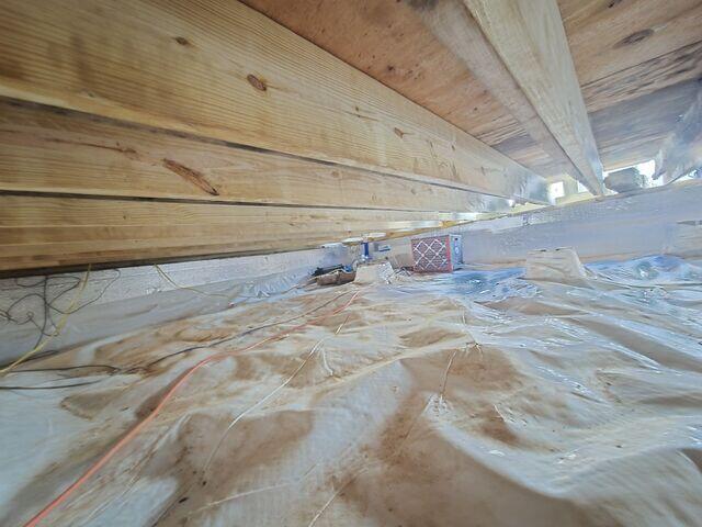 This area shows the corner where we installed our sump pump and dehumidifier. We also repaired a lot of the joists in this area. While this photo was snapped, our crew was finishing up replacing the band boards/sill plates, which is why you can see light from the outside.