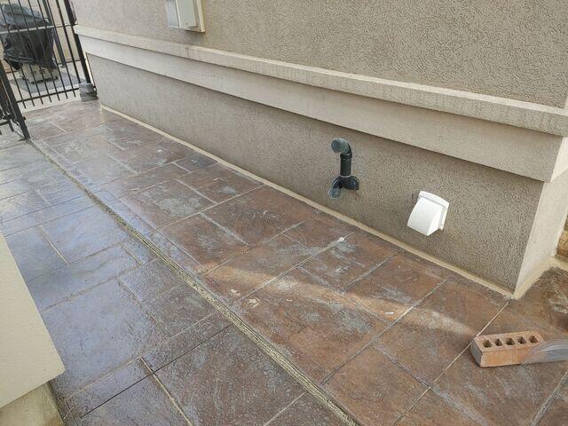 A detailed look at the side walkway following the application of our stabilizing material. This shot showcases the removal of the old, failing filler, now replaced with a smooth, watertight bead of our premium sealant along the foundation wall. It's the perfect defense against water washouts and future settling.
