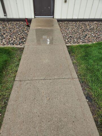 The sidewalk leading up to the building before our crew lifted and leveled the area