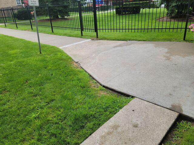 The final image captures a corner section where the concrete had significantly sunken away from the lawn and adjacent slabs. We successfully raised this area to be flush with the rest of the path, eliminating the drop-off and preventing water from pooling against the edges.