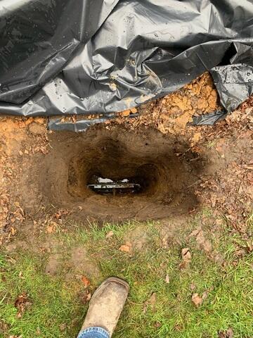 The crew in the process of installing GeoLocks. They placed the earth anchor and connected it to the interior wall