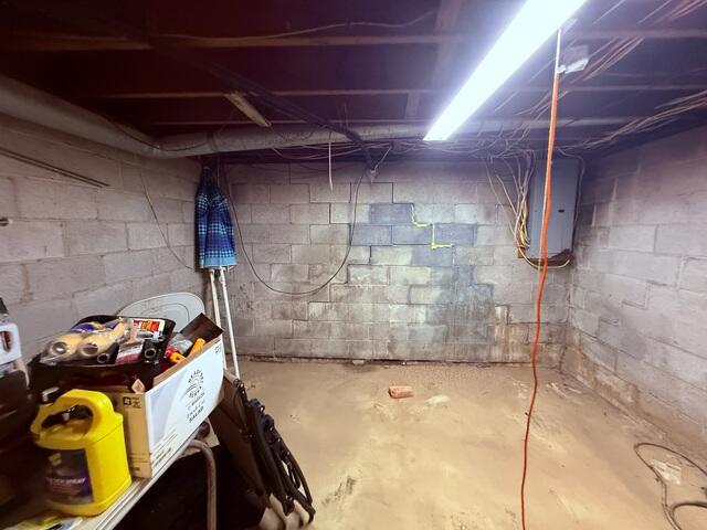 Stair-step cracks in the block foundation wall are a classic sign of settlement.