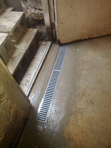 Once installed, the crew re-concretes the basement perimeter for a seamless finish,