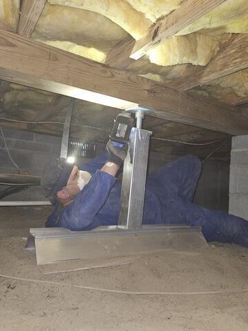 Installing SmartJacks to lift a sagging floor.