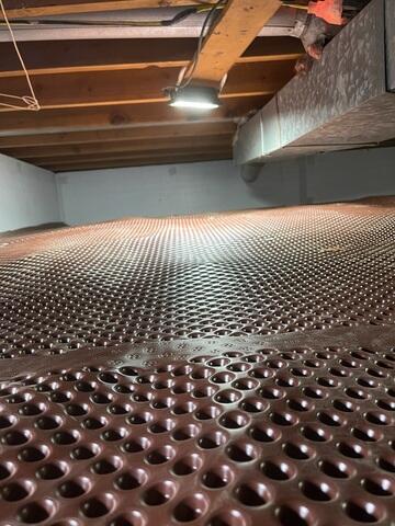 The crew added Drainage Matting along the crawl space floor