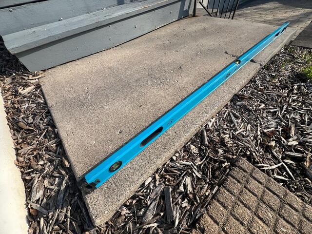 A close-up of the slabs where it has become uneven and a few cracks have formed