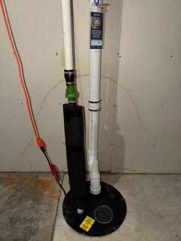Our crew installed piping through the sump pump, connected it to the fan installed at the exterior of the home