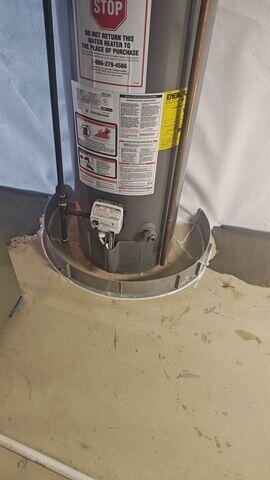 We install a floor dam around appliances like this water heater to protect them against flooding.