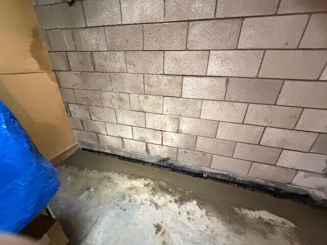Perimeter trench prepared and WaterGuard drainage system installed along the interior foundation wall.