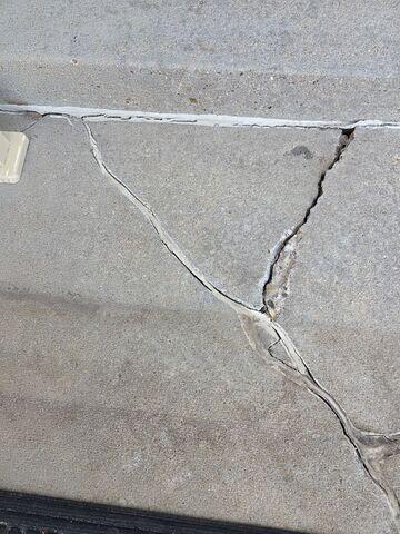 Before: Our Design Specialist, Dylan, recommended lifting the sunken, damaged concrete back to its original level.