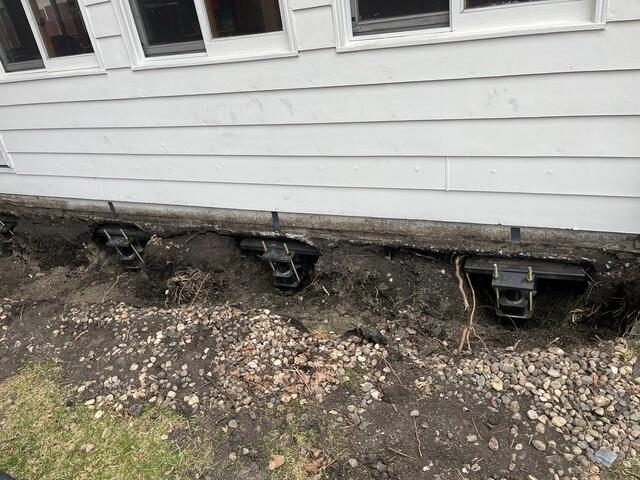During: The crew secured Helical Piers below the sinking foundation.
