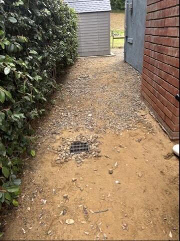 After photo of the side of home, with french drain system installed.