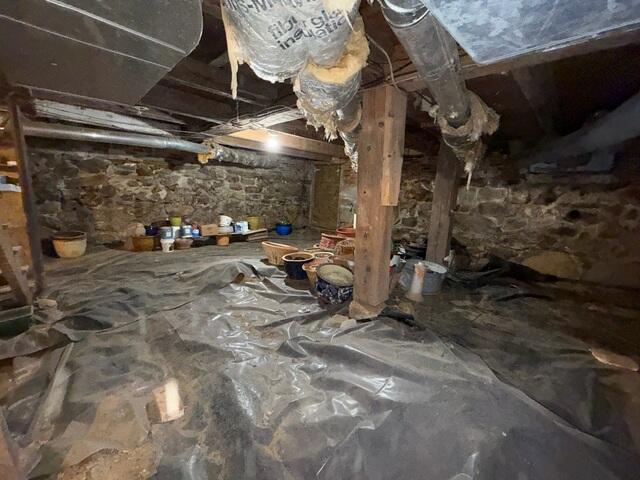 This wet crawl space in Sullivan, New Hampshire, is infiltrated by groundwater and wall seepage during every hard rainstorm.