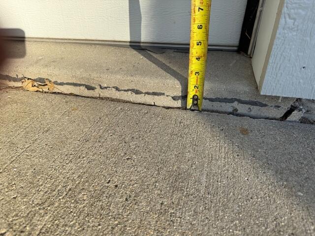 Before: Our Design Specialist, Tony, measured a significant drop and recommended lifting and leveling the damaged concrete back to its original level.