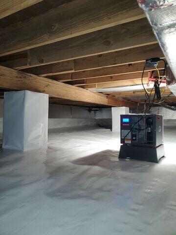 The SaniDry Sedona dehumidifier pictured here works to keep the crawl space humidity low, protecting the wooden floor joists and inhibiting mold growth.