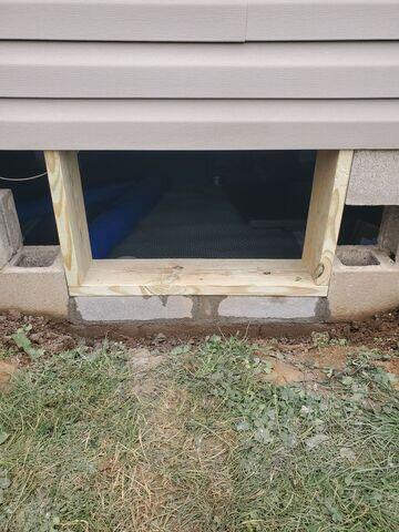 The crew expanded the crawl space access and framed it.