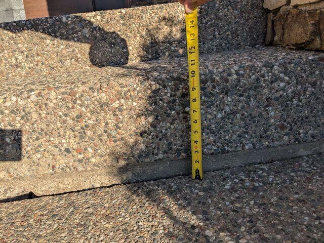 A close-up of one of the steps where the slabs have sunken over 2 inches