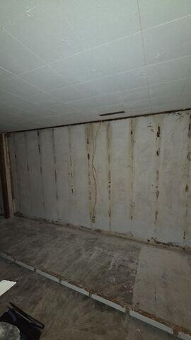 Before: Our Design Specialist, Derek, suggested waterproofing the water-damaged basement.