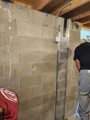 Our crew in the process of applying epoxy to keep the carbon fiber straps in place