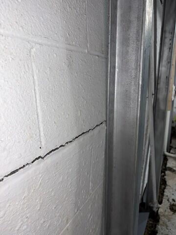 The crew installs static beams to stabilize the bowing walls.