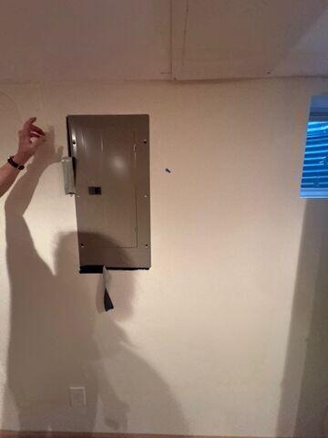 Drywall holes around breaker box
