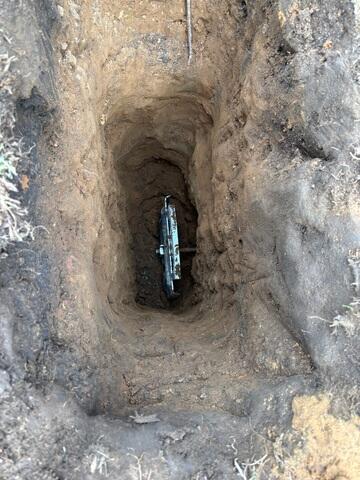 The earth anchor is placed inside of the hole and connected to the interior wall plate using a small steel pole