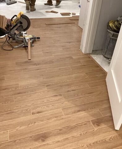 The Elite Plank Flooring in Pecan refinishes this basement's floor while being water and mold resistant!